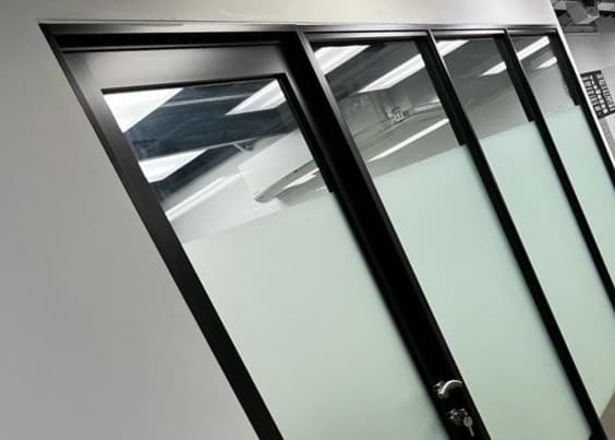 Technician installing a tempered glass door