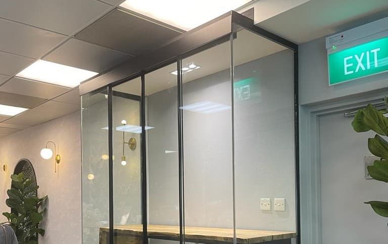 Technician installing a tempered glass door